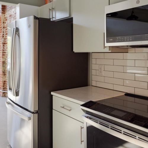 Spacious kitchens with thoughtful details a kitchen with white cabinets and stainless steel appliances